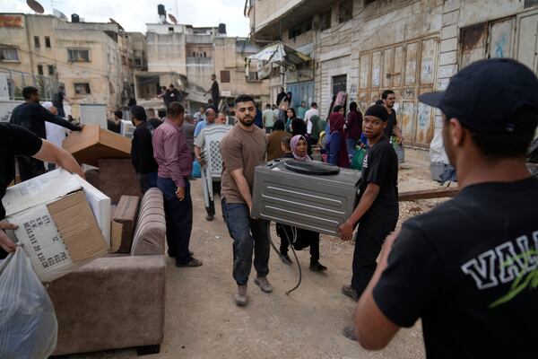 Residents of the now evacuated refugee camp of Tulkarem return to collect belongings before the destruction of their homes as Israeli forces prepare to carry out the demolition of 116 homes across the two refugee camps of the Israeli occupied West Bank city of Tulkarem, Friday, May 2, 2025. (AP Photo/Nasser Nasser)