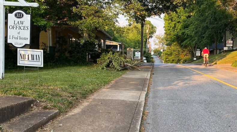 A "No-One Way" yard sign sits in front of a law firm along Lawrence Street in Marietta on May 25, 2021. Marietta City Council is expected to make a decision on the fate of traffic flow along the residential road Wednesday night. (Photo by Matt Bruce/For AJC)