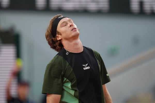 Russia's Andrey Rublev reacts as he plays against Italy's Jannik Sinner during their fourth round match of the French Tennis Open at the Roland-Garros stadium in Paris, Monday, June 2, 2025. (AP Photo/Aurelien Morissard)