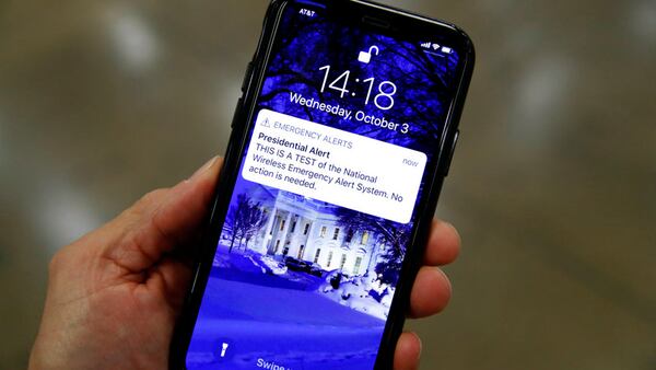 A presidential emergency alert test is seen on a phone on Capitol Hill, Wednesday, Oct. 3, 2018 in Washington. (AP Photo/Alex Brandon)