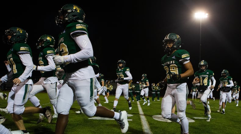The Blessed Trinity varsity football team takes the field before the Blessed Trinity vs. Decatur high school football game on Friday, December 4, 2020, at Blessed Trinity high school in Roswell, Georgia. Blessed Trinity defeated Decatur 44-0 in the second round playoff game.  CHRISTINA MATACOTTA FOR THE ATLANTA JOURNAL-CONSTITUTION.