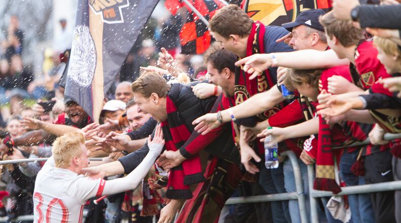Atlanta United fans celebrate with midfielder Andrew Carrolton (30) after he scored the team’s fourth goal in a 4-0 exhibition game win over Chattanooga FC of the NPSL. Atlanta United opens its inaugural season Sunday at Bobby Dodd Stadium. (Miguel Martinez/MundoHispanico)