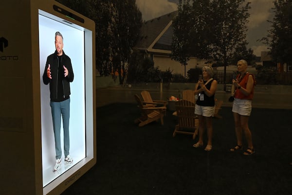 Studio guests watch a hologram video presentation from comedian Nate Bargatze on the set of “The Breadwinner,” which starred Bargatze and was filmed at Trilith Studios in Fayetteville. (Hyosub Shin/AJC)