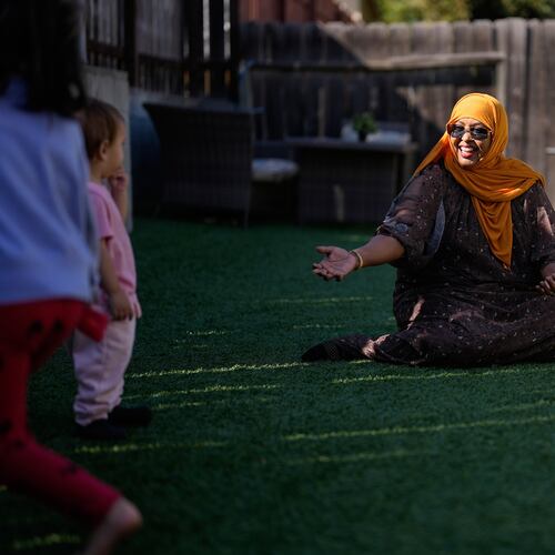 Samsam Khalif plays with children at her home-based child care center Friday, Jan. 30, 2026, in San Diego. (AP Photo/Gregory Bull)