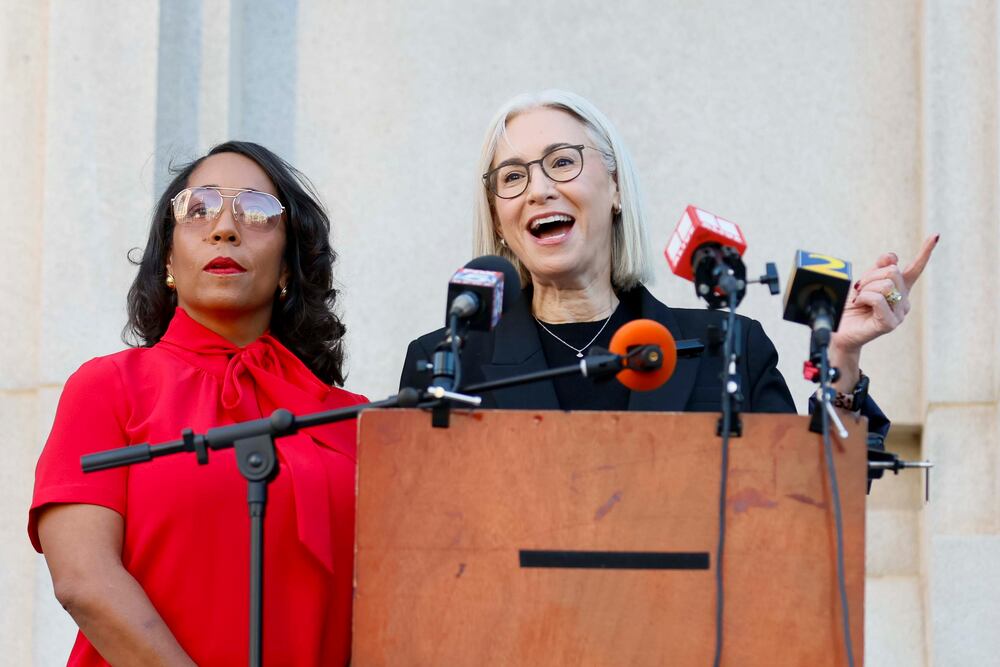 Mo Ivory (left) and Dana Barrett, Democrats on the Fulton County Board of Commissioners, held a news conference outside of the county's Superior Court on Wednesday.
