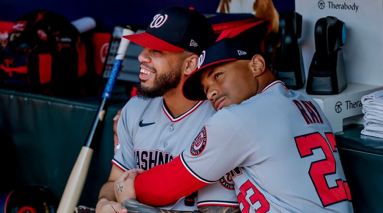 Washington Nationals first baseman Luis García Jr., left, is hugged in the dugout by first base coach Corey Ray (23) after he was scratched from the starting lineup before a baseball game against the Atlanta Braves, Sunday, Aug. 2, 2026, in Atlanta. (AP Photo/Erik S. Lesser)