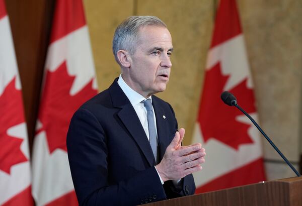 Canada Prime Minister Mark Carney speaks with media on Parliament Hill following a meeting of the Cabinet Committee on Canada-U.S. Relations and National Security, in Ottawa, Thursday, March 27, 2025. (Adrian Wyld/The Canadian Press via AP)