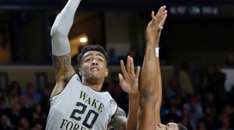 FILE - In this Wednesday, Jan. 11, 2017 file photo, Wake Forest's John Collins (20) shoots over North Carolina's Kennedy Meeks (3) during the first half of an NCAA college basketball game in Winston-Salem, N.C. The role of the big man has changed in the NBA, and that’s evident in the way teams pick centers and post players entering the draft on Thursday, June 22, 2017. The Wake Forest sophomore is projected as a first-round pick for Thursday's NBA draft. (AP Photo/Chuck Burton, File)