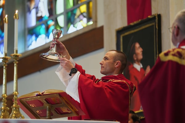 The Rev. Mike Sampson gives his first Mass at St. Charles Borromeo Catholic Church in Arlington, Va., on Sunday, June 8, 2025. (AP Photo/Jessie Wardarski)