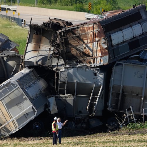 Workers respond after a train derailed on Wednesday, June 3, 2026, near Victor, Iowa. (AP Photo/Charlie Neibergall)