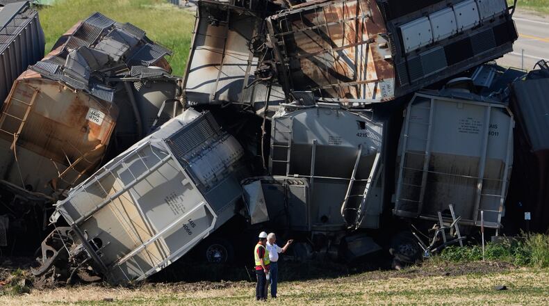 Workers respond after a train derailed on Wednesday, June 3, 2026, near Victor, Iowa. (AP Photo/Charlie Neibergall)