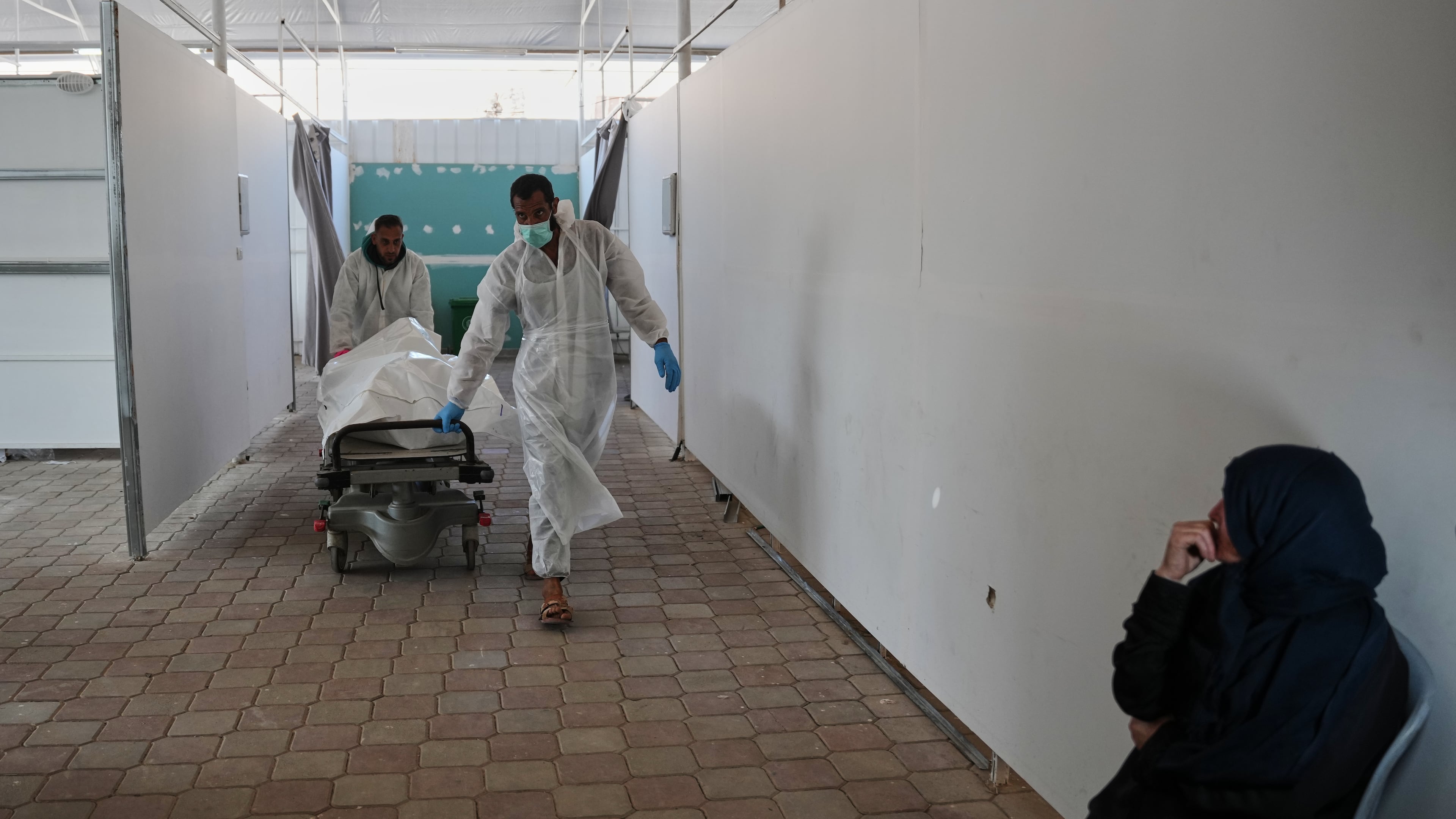 Bodies of unidentified Palestinians returned from Israel as part of the ceasefire deal are brought to Nasser Hospital in Khan Younis, Gaza Strip, Saturday, Nov. 8, 2025. (AP Photo/Abdel Kareem Hana)