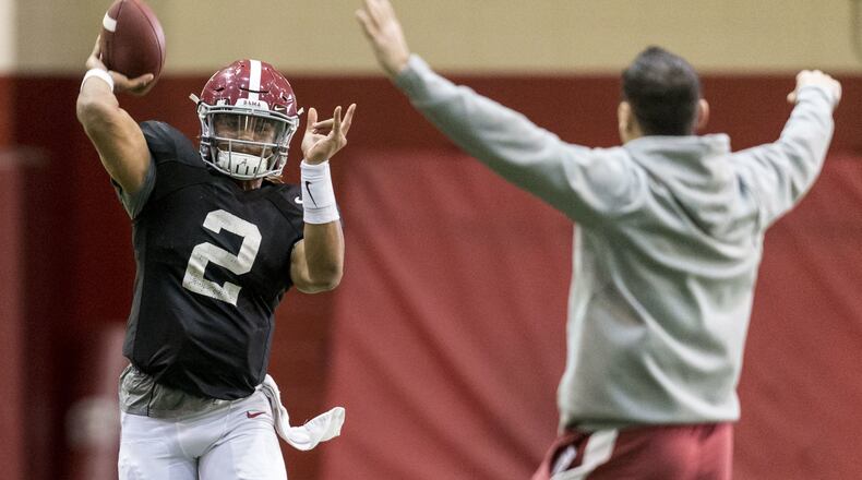 Alabama quarterback Jalen Hurts (2) throws around offensive coordinator Steve Sarkisian during a quarterback drill at football practice, Wednesday, Jan. 4, 2017, in Tuscaloosa, Ala. (Vasha Hunt /AL.com via AP)