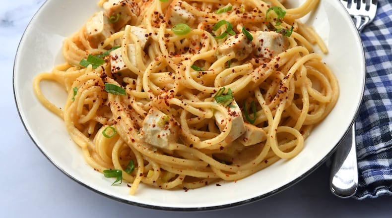 This miso butter noodles dish with tofu uses a sauce made with sautéed scallions and gochugaru, the Korean red chile flakes used in kimchi. Chris Hunt for The Atlanta Journal-Constitution