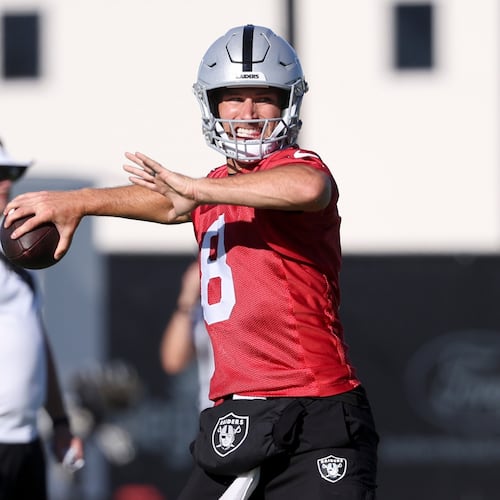 Las Vegas Raiders quarterback Kirk Cousins (8) throws a pass during practice at the team's NFL football training camp, Thursday, July 30, 2026, in Henderson, Nev. (AP Photo/Ian Maule)