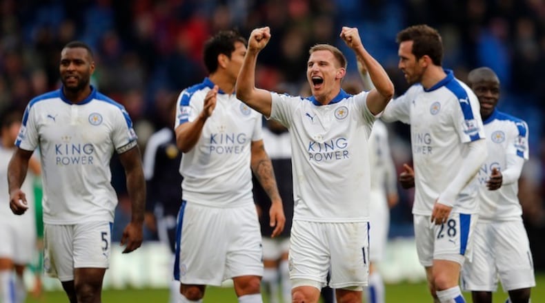 Leicester players celebrate after winning the English Premier League soccer match between Crystal Palace and Leicester City at Selhurst Park stadium in London, Saturday, March 19, 2016.(AP Photo/Frank Augstein)