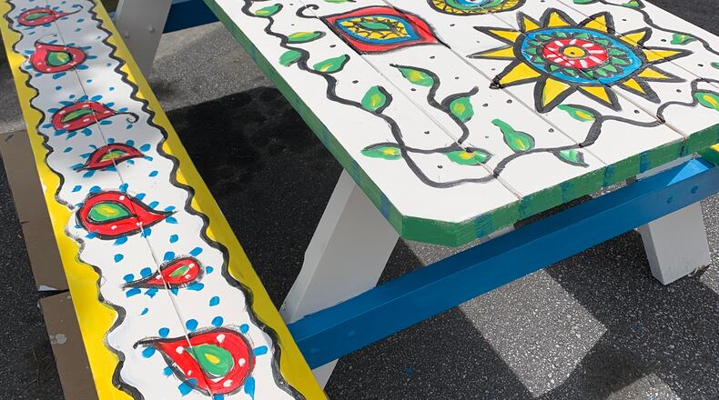 Dunwoody’s Economic Development Department is connecting local restaurants with community groups to add a creative touch to outdoor dining. This picnic table was painted by the Dunwoody Fine Art Association for Vino Venue. CONTRIBUTED