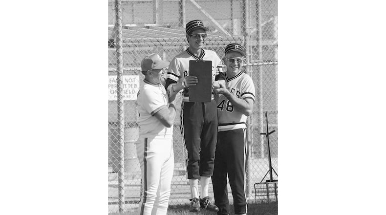 FILE - Pittsburgh Pirates pitching coach Harvey Haddix, center, gets a lift from former teammates Vernon Law, left, now pitching coach for the Seibu Lions, from Japan, and Pirates coach Bob Skinner, right, at the baseball team's spring training complex in Bradenton, Fla., Feb. 23, 1979. (AP Photo/File)