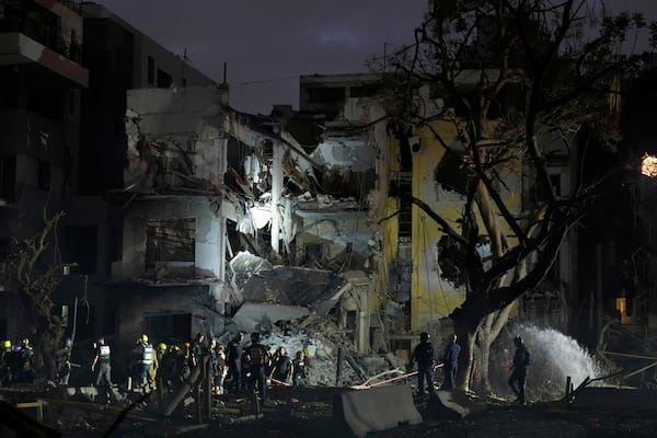 Rescue team work at the site where a missile launched from Iran struck Tel Aviv, Israel, Monday, June 16, 2025. (AP Photo/Baz Ratner)