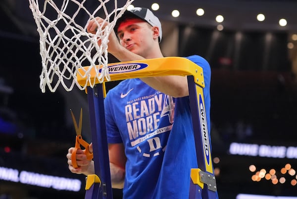 Duke forward Cooper Flagg (2) cuts a piece of the net after Duke defeated Alabama in an Elite Eight round NCAA college basketball tournament game, Saturday, March 29, 2025, in Newark, N.J. (AP Photo/Frank Franklin II)