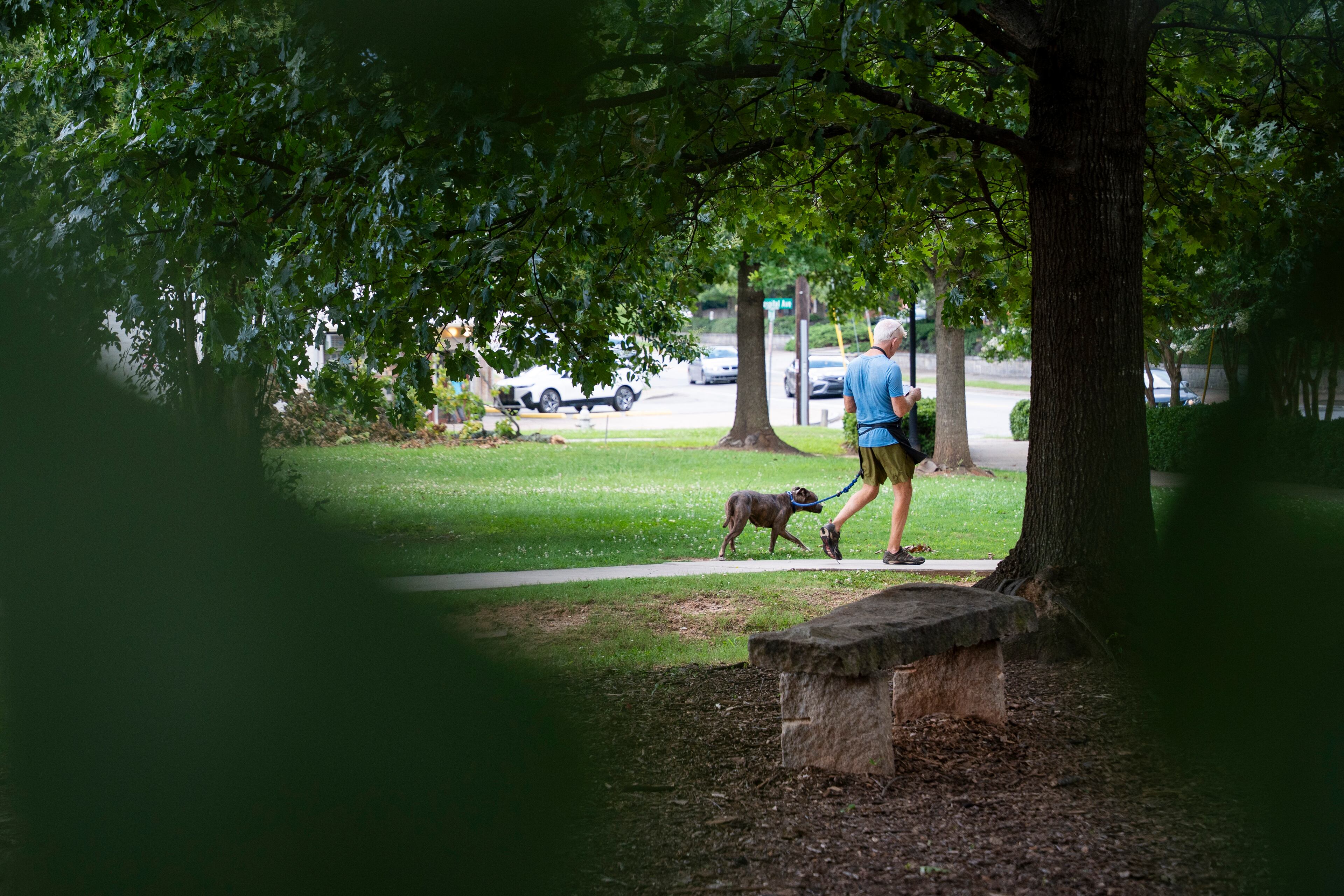 A volunteer takes a dog for a walk at the DeKalb Animal Shelter on Tuesday, July 1, 2025, in Chamblee. (Olivia Bowdoin for the AJC)