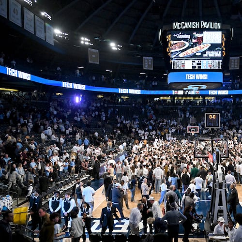 Fans storm the court after a Georgia Tech victory at McCamish Pavilion. (Hyosub Shin/AJC)