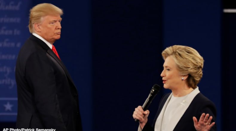 Republican presidential nominee Donald Trump listens to Democratic presidential nominee Hillary Clinton during the second presidential debate at Washington University in St. Louis, Sunday, Oct. 9, 2016. (AP Photo/Patrick Semansky)