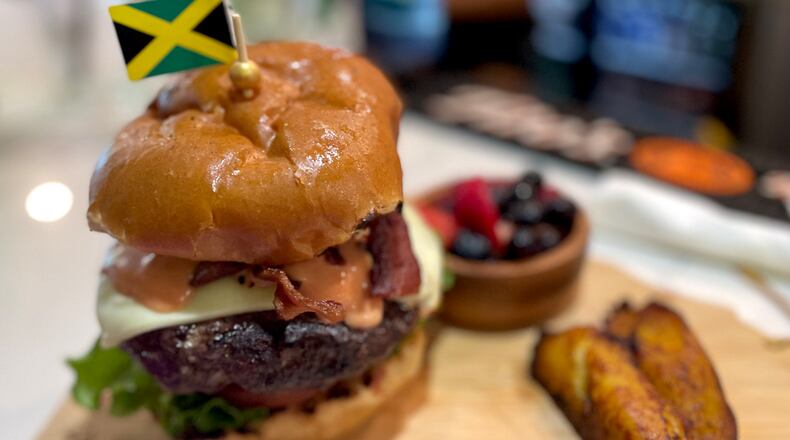 The Hangover Brunch burger comes with a fried egg and thick, crisp bacon, and is infused with Jamaican jerk, as well. Angela Hansberger for The Atlanta Journal-Constitution
