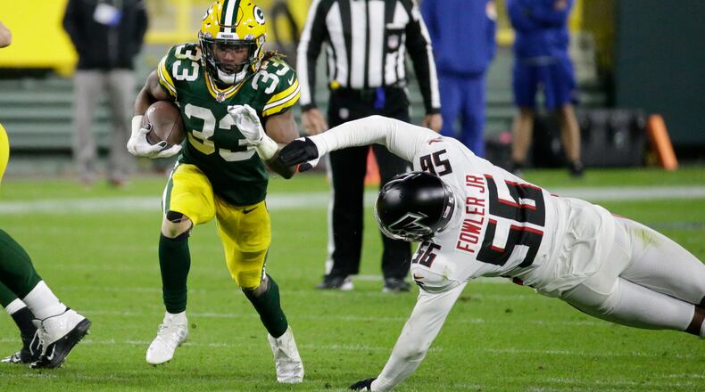 Packers RB Aaron Jones runs past Dante Fowler of the Falcons during the second half of Monday's game. (Mike Roemer/Associated Press)