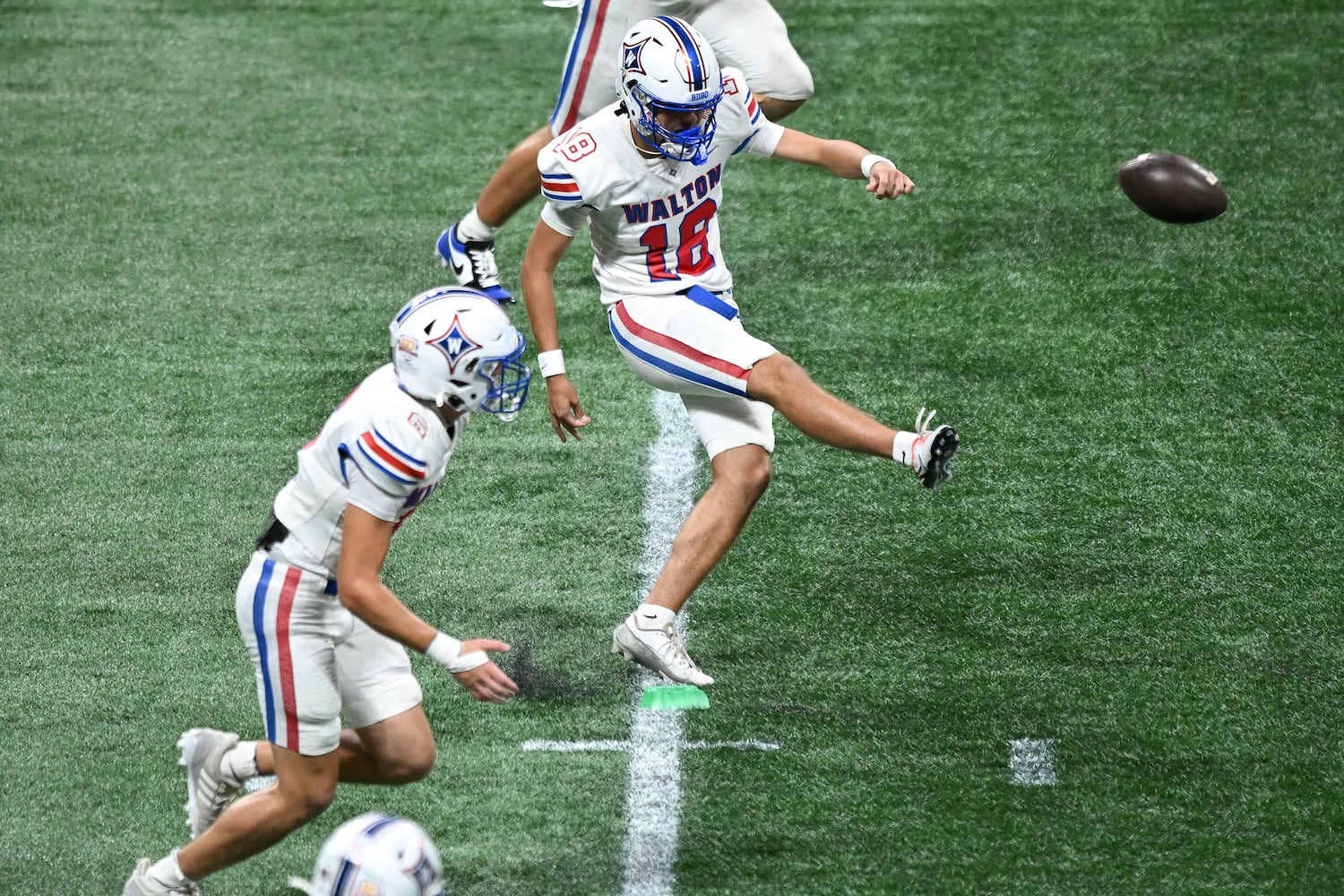 Walton kicker kicker Daniel Stricklin (18) sends the ball downfield during the second half of the Corky Kell Classic football game Saturday, August 16, 2025 at the Mercedes-Benz Stadium. (Daniel Varnado/For the Atlanta Journal-Constitution)