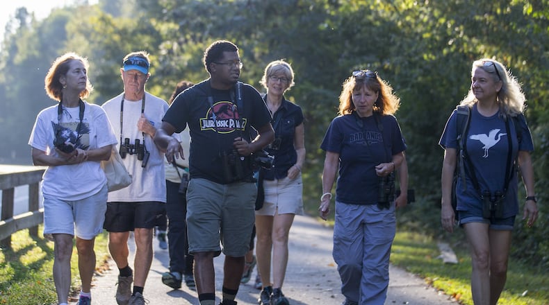 Atlanta Audubon field trip leader Jason Ward (third from left) leads a group of bird watchers during a walk at Azalea Park in Roswell, Thursday, September 6, 2019. (Alyssa Pointer/alyssa.pointer@ajc.com)