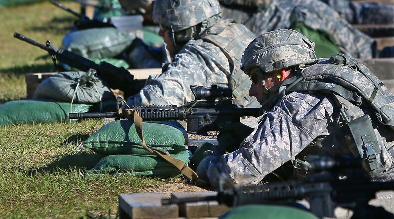 Maj. Matt Howard (left), of Dahlonega, and Capt. Craig Keller (right), of Marietta, zero their weapons at the firing range while training for deployment to Afghanistan at Fort Stewart on Wednesday, Nov. 13, 2013. A fellow soldier was injured this week during a “live fire” training exercise at the military installation. CURTIS COMPTON /staff CCOMPTON@AJC.COM