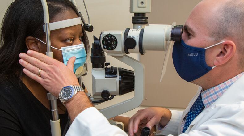 Dr. Scott Moscow examines Jenita Holbrook at Roswell Eye Clinic in Roswell. PHIL SKINNER FOR THE ATLANTA JOURNAL-CONSTITUTION.