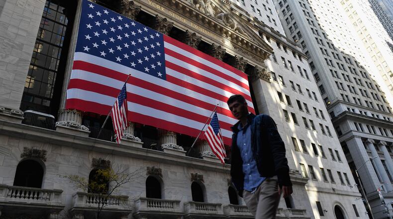 The S&P 500 and the Dow Jones Industrial Average ended 2020 at more record highs Thursday, closing out one of the most tumultuous years in recent memory. (Angela Weiss/AFP/TNS)