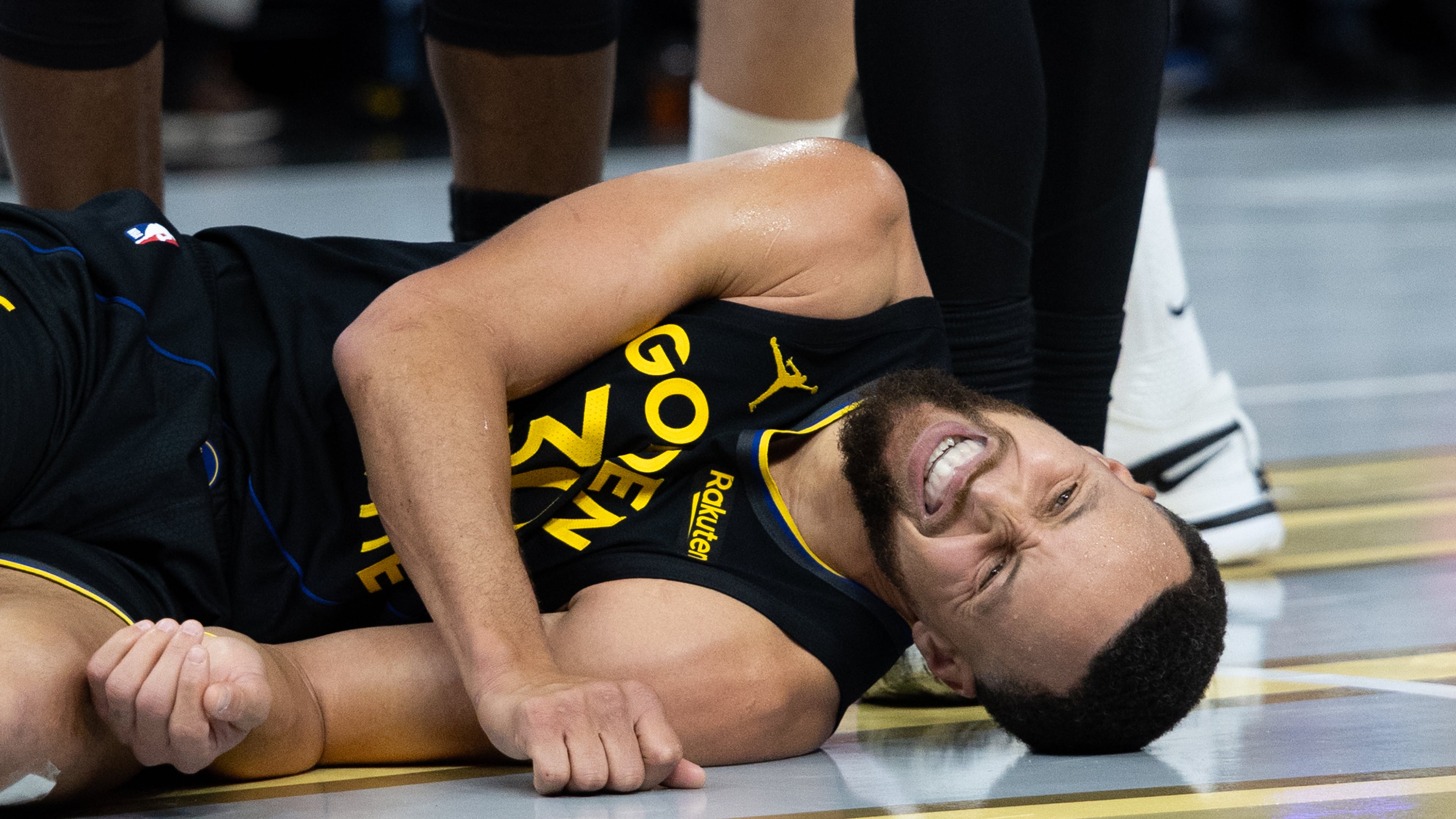 Golden State Warriors guard Stephen Curry lies on the floor during the second half of an Emirates NBA Cup basketball game against the Houston Rockets Wednesday, Nov. 26, 2025, in San Francisco. (AP Photo/Benjamin Fanjoy)