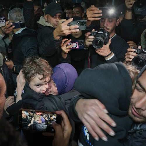 Najat Rubaie, center right, embraces one of her grandsons after they arrive with their mother as part of a group of about a dozen Palestinian returnees allowed into Gaza following the long-awaited reopening of the Rafah border crossing, at Nasser Hospital in Khan Younis, southern Gaza Strip, early Tuesday, Feb. 3, 2026. (AP Photo/Abdel Kareem Hana)