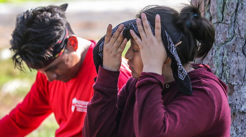 2023 the warmest year on Earth since pre-industrial times, and U.S. weather scientists say it was significantly warmer than the last record that was set in 2016, RCB Roofing's Miguel Lopez (left) takes a break as co-worker Anayelli Perez (right) wipes the sweat away as they were putting on a new roof for an Atlanta resident in the 1800 block of Shepherd Circle SW on Thursday, July 20, 2023. (John Spink / AJC)