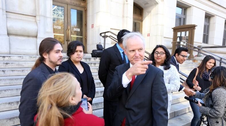 Atlanta immigration attorney Charles Kuck talks with plaintiffs outside the Fulton County Superior Court in December. MIGUEL MARTINEZ/MUNDO HISPANICO
