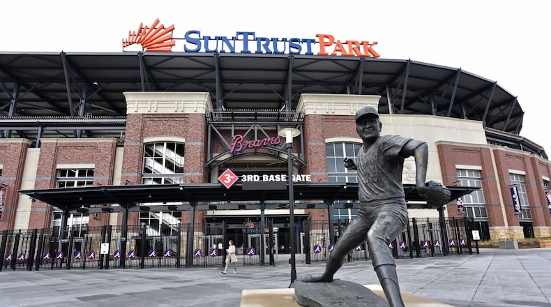 A statue of former Braves pitcher Phil Niekro stands before the third-base gate at SunTrust Park. (Hyosub Shin/hshin@ajc.com)