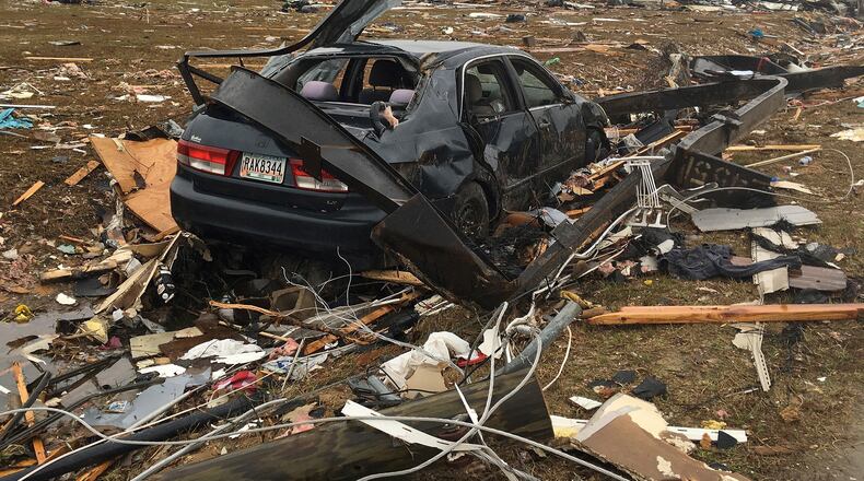 A vehicle sits in a debris field in the aftermath of a possible tornado in Adel, Ga., in January. (AP Photo/Brendan Farrington)
