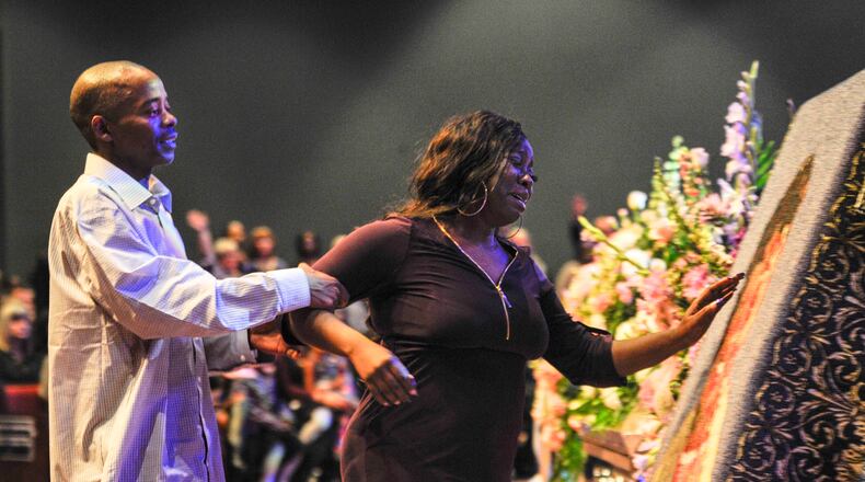 LaTesha Jones, right, is escorted by her father, Dedrick Allen, as she reaches for an image of her daughter, Cor’Dayja Jones, that is imprinted on a blanket during Cor’Dayja’s funeral of at the Redemption Point Church on Saturday in Chattanooga, Tenn. (Lacy Atkins/The Tennessean via AP)