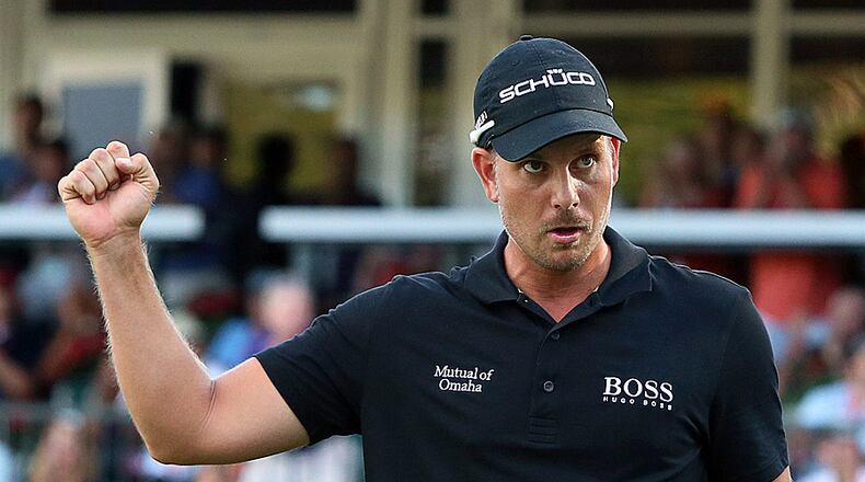 092213 Atlanta: Henrik Stenson pumps his fist on the 18th green sinking his putt to win the Tour Championship, the FedEx Cup, and about 11.4 million in money and prizes with a total of 13-under par at East Lake Golf Club on Sunday, Sept. 22, 2013, in Atlanta. CURTIS COMPTON /staff CCOMPTON@AJC.COM