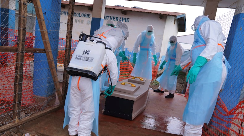 Health workers disinfect a coffin of an Ebola victim at Ebola Treatment Center at Bunia General Hospital in Ituri, Congo, Wednesday, July 22, 2026. (AP Photo/Dirole Lotsima Dieudonne)