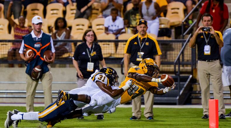 Sophomore running back Darnell Holland (33) dives for the pylon as junior cornerback Paul Hunter (31) makes a touchdown-saving tackle, Saturday, Sept. 3, 2016 (AJC/Cory Hancock)