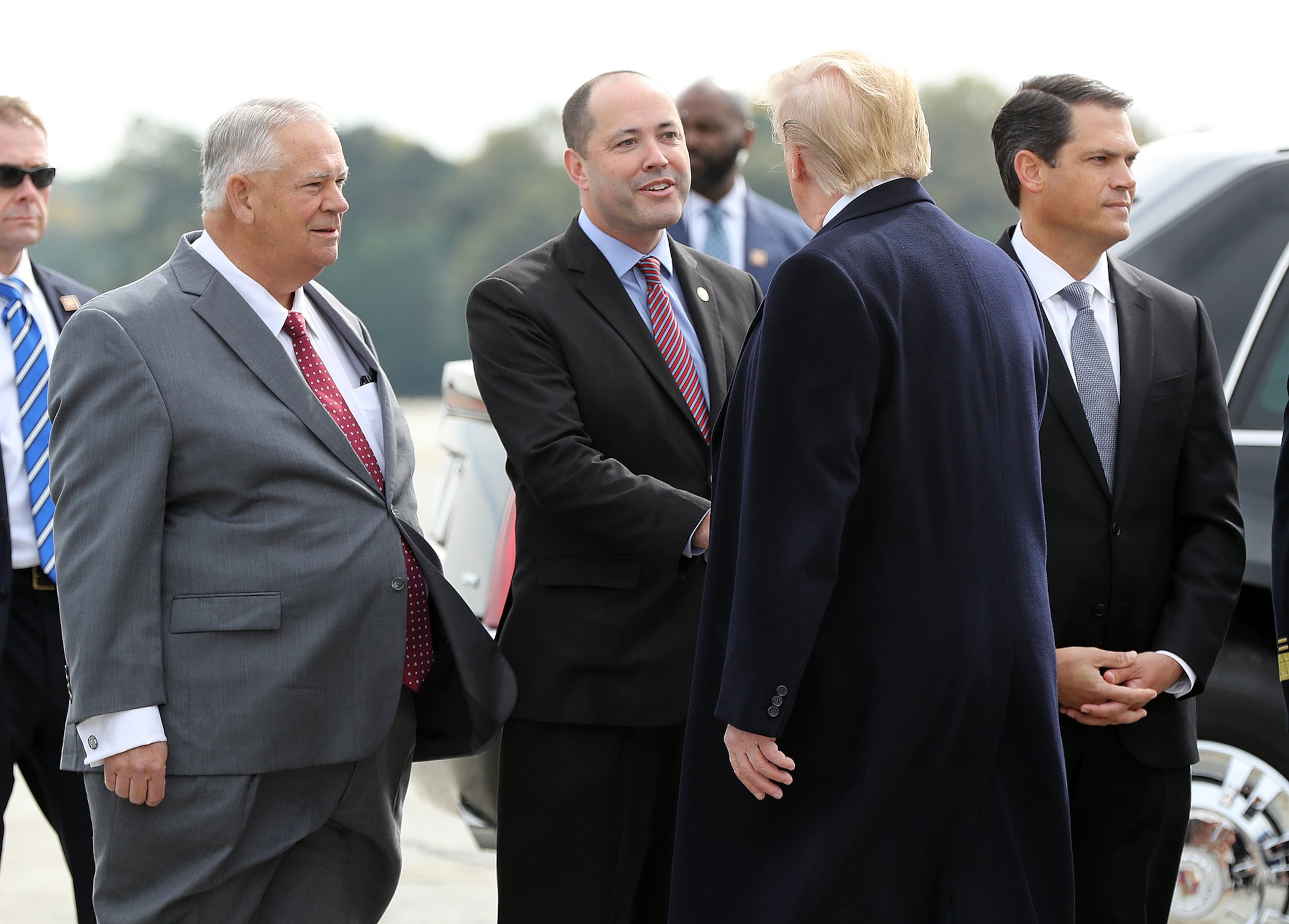 Former Georgia House Speaker David Ralston (left), Attorney General Chris Carr (center), and former Lt. Gov. Geoff Duncan (right) greet President Donald Trump after he arrived at Dobbins Air Reserve Base on Nov. 8, 2019. (Curtis Compton/AJC)