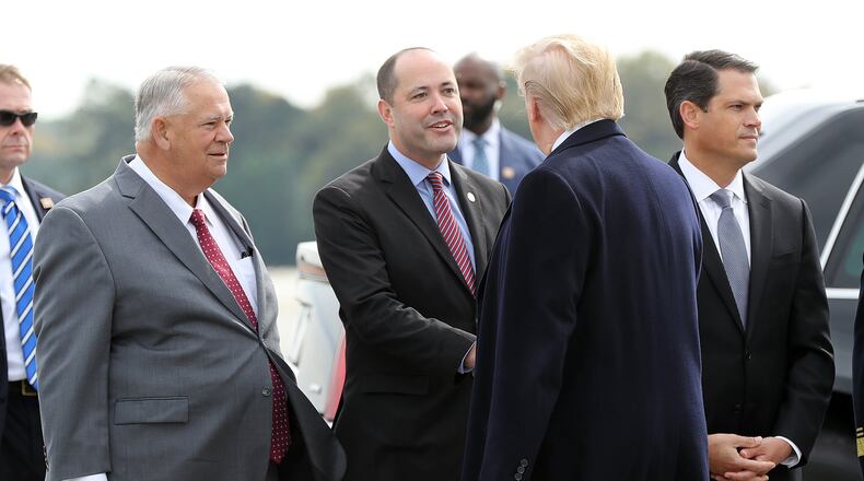 Georgia House Speaker David Ralston (left), Attorney General Chris Carr (center), and Lieutenant Governor Geoff Duncan (right) greet President Donald Trump after he arrived at Dobbins Air Reserve Base on Nov. 8, 2019. Curtis Compton/ccompton@ajc.com