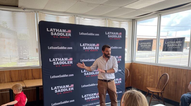 Republican U.S. .Senate candidate Latham Saddler addresses a crowd in Nashville, Ga., as his son Bubba wanders the room. Saddler was relatively unknown when he launched his bid, but he has built a serious campaign and holds the fundraising edge among Republicans with $1.4 million.