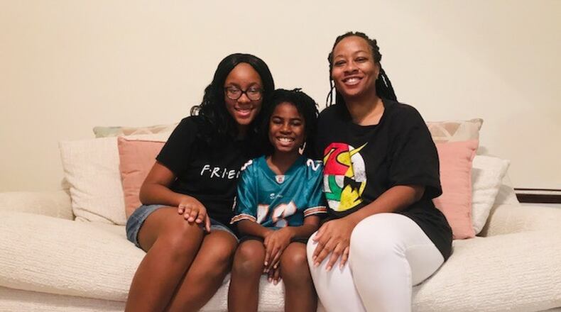 DaVina Jackson (right) of Fort Valley, Georgia, and her children, daughter JeNaii (left) and son JeKaii (center) returned from China last week. They are seen here at her mother’s house, where they are waiting out the two-week quarantine period. CONTRIBUTED: DAVINA JACKSON