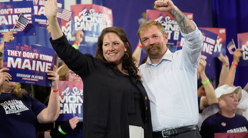 Democratic U.S. Senate candidate Graham Platner, right, and his wife Amy Gertner gesture to supporters during a primary election night watch party Tuesday, June 9, 2026, in Blue Hill, Maine. (AP Photo/Robert F. Bukaty)