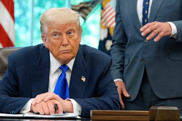 President Donald Trump listens as Health and Human Services Secretary Robert F. Kennedy Jr. speaks as he signs executive orders and proclamations in the Oval Office of the White House, Monday, May 5, 2025, in Washington. (AP Photo/Alex Brandon)